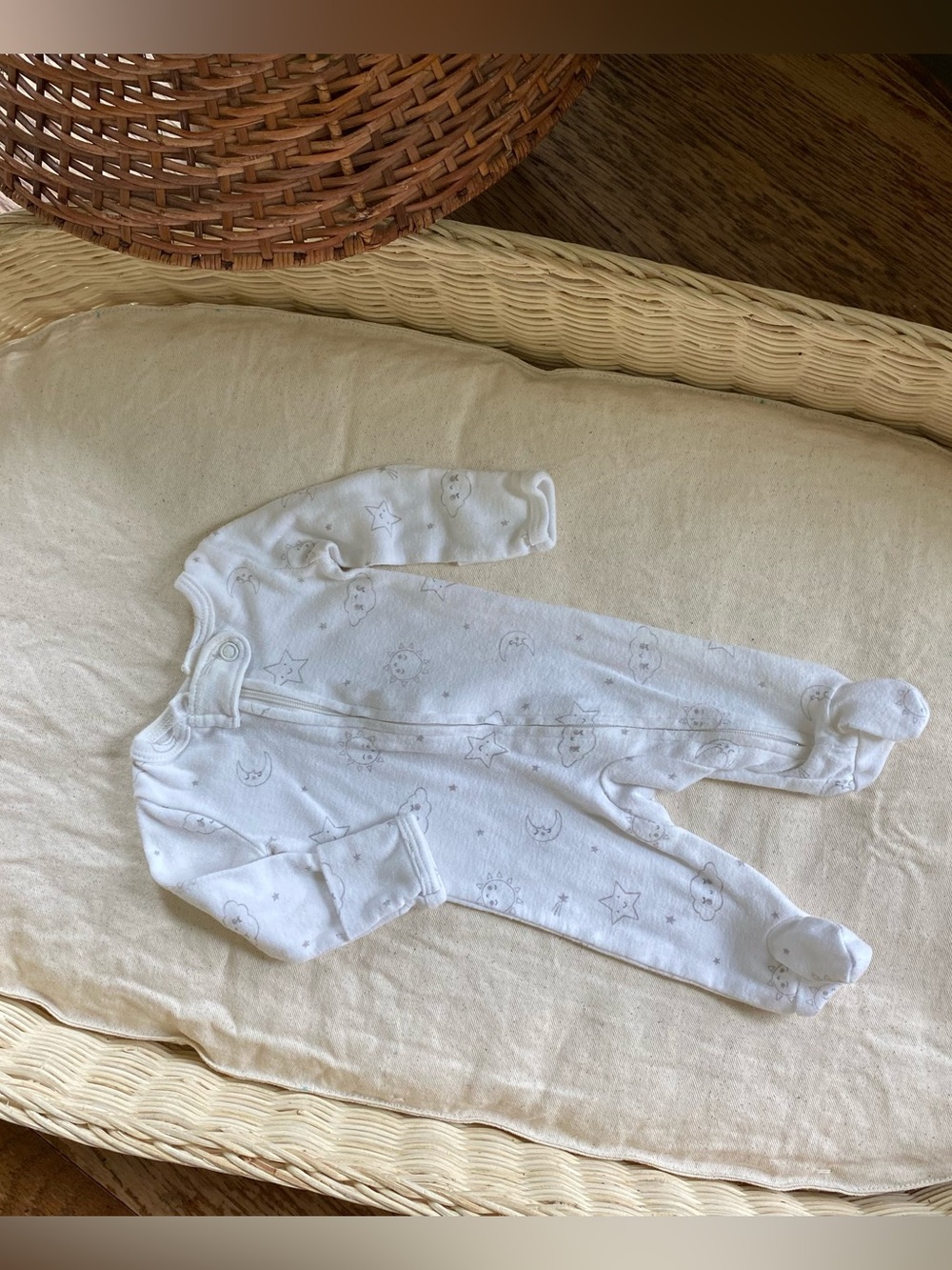 Carter's preemie white baby footed zipper sleeper with moon and stars print.
